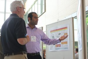Ali Arabzadeh (left) presents research during the PEGASAS Annual Meeting student poster session