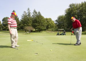 Cleasby (left) and Sanders watch for the outcome of a putt (Photo by Kate Tindall)