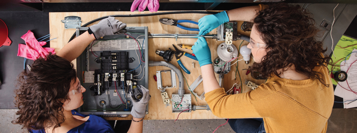 Female students working on an electrical project.